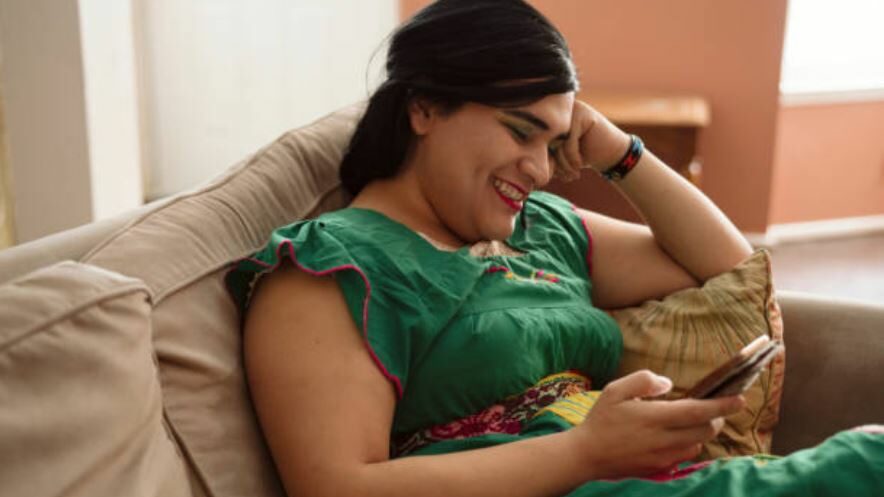 a happy Hijra on a couch