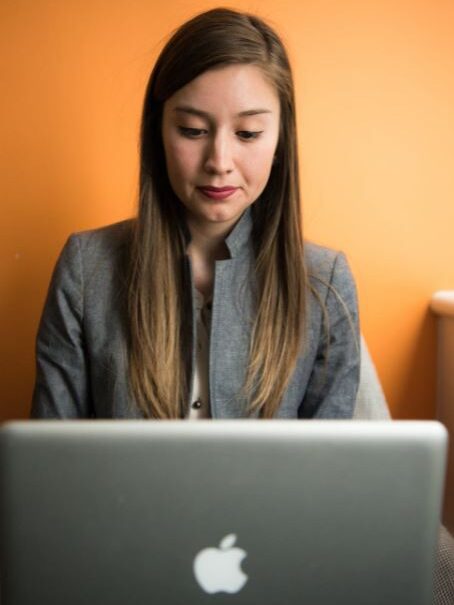 a woman front of a laptop