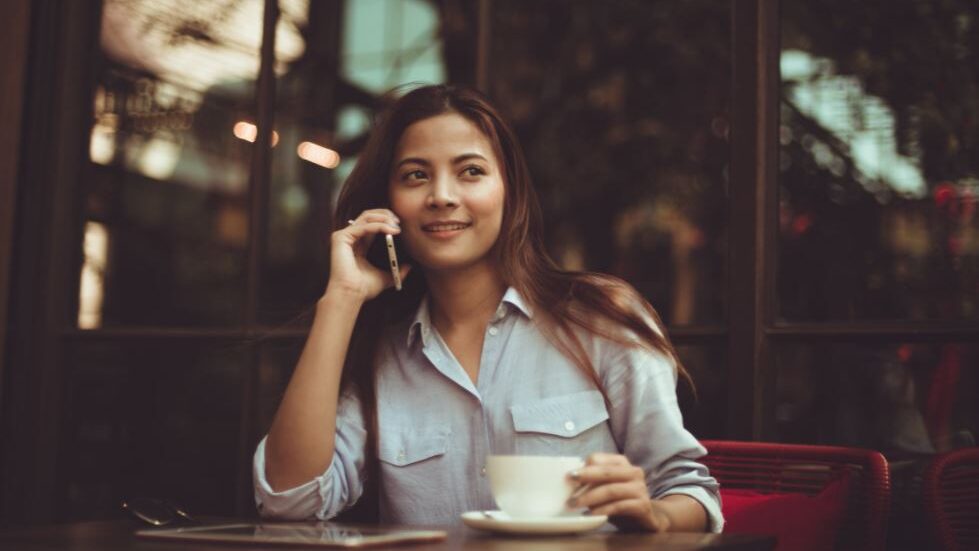 a woman smiling while a phone call