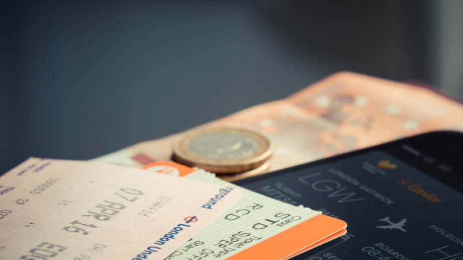 Boarding pass with a coin and a smartphone displaying flight details.