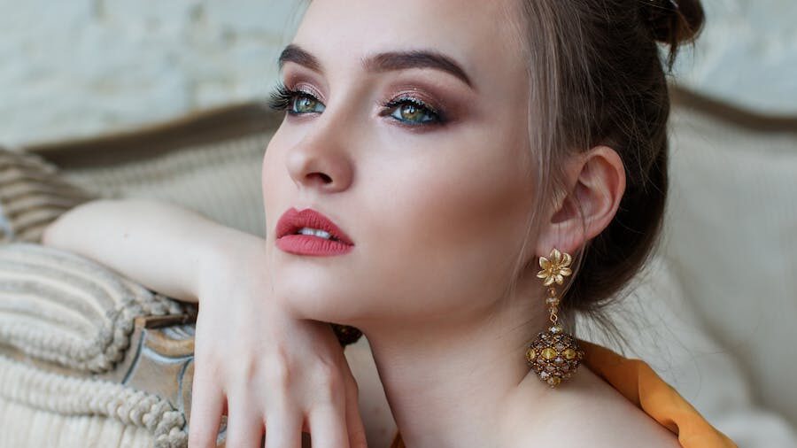 A glamour shot of a woman with polished makeup and ornate jewelry, exuding sophistication and poise.