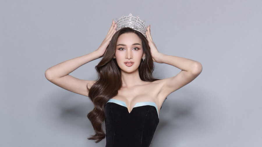Andoi wears a strapless black dress and crown while posing for her official Miss International Queen Thailand 2025 portrait.